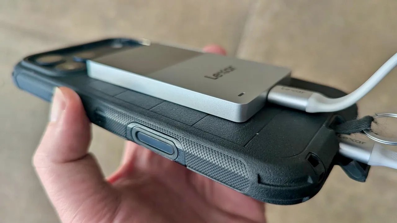 The drive is super thin and light, and is dwarfed by the iPhone.