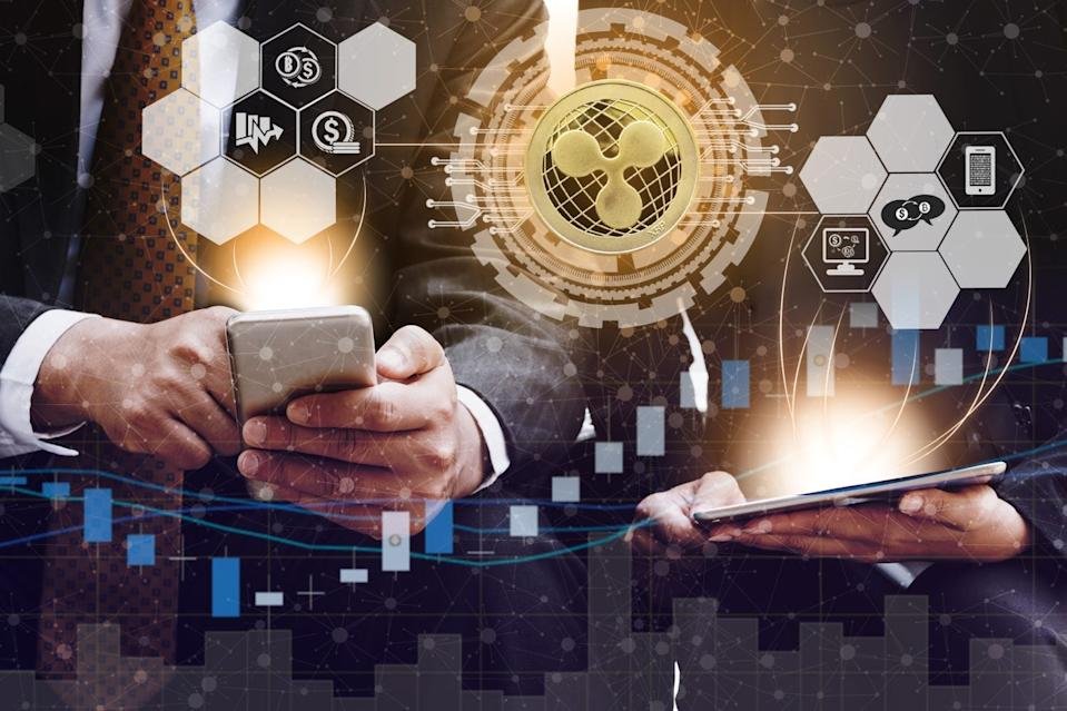 Ripple and cryptocurrency investing concept - Businessman using mobile phone application to trade Ripple XRP with another trader in modern graphic interface. Blockchain and financial technology.