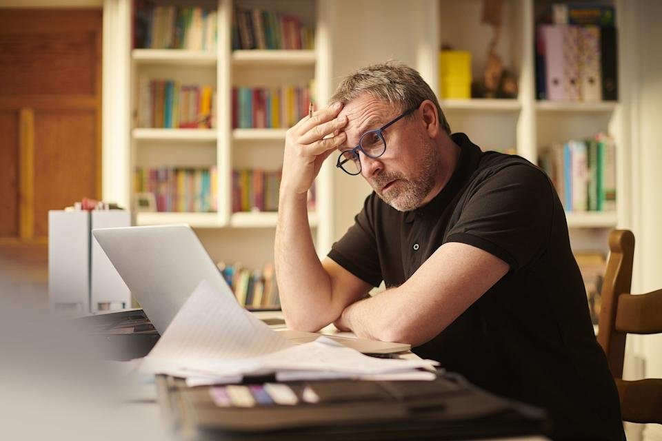 Stressed person sitting in front of a laptop computer.