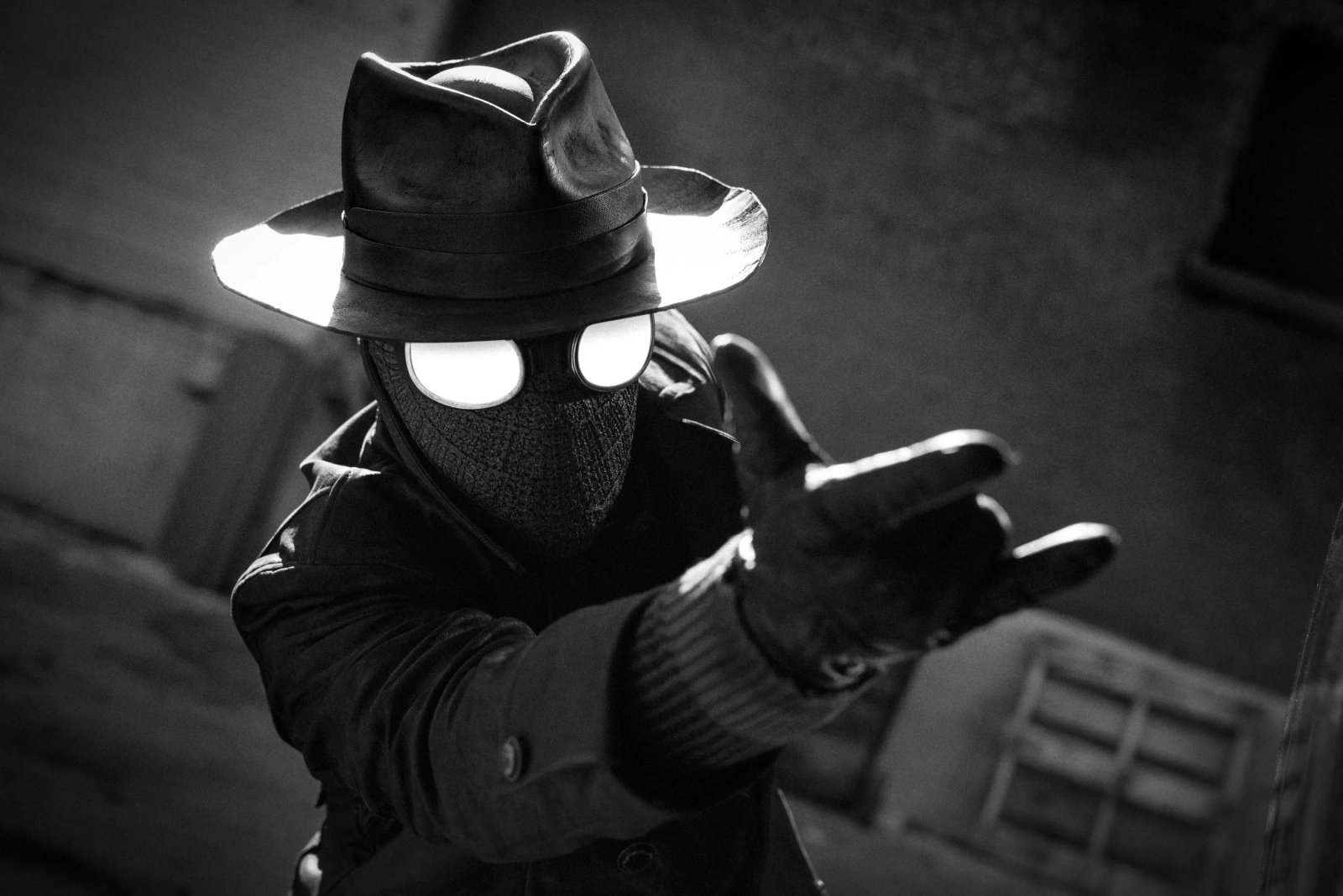 A black and white image of Spider-Man noir getting ready to shoot some webs.