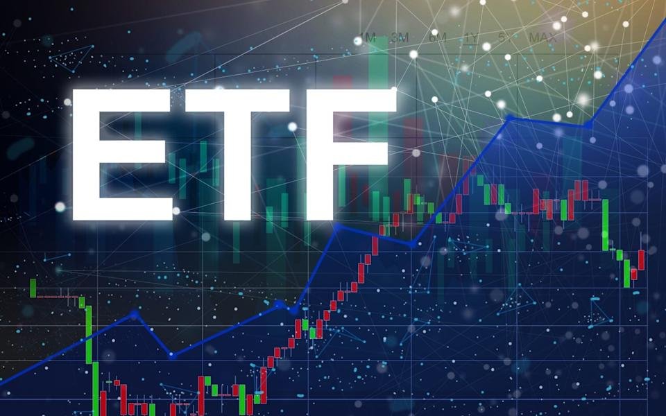 The letters 'ETF' in bold, glowing white text are centered over a dark blue background with an overlaid digital network pattern of lines and dots. Behind the text, a financial market chart is visible, displaying red and green candlestick bars and a prominent blue line graph trending upwards from the bottom left to the top right. The chart also shows faint indicators for timeframes like '1M', '3M', '6M', '1Y', '5Y', and 'MAX'.