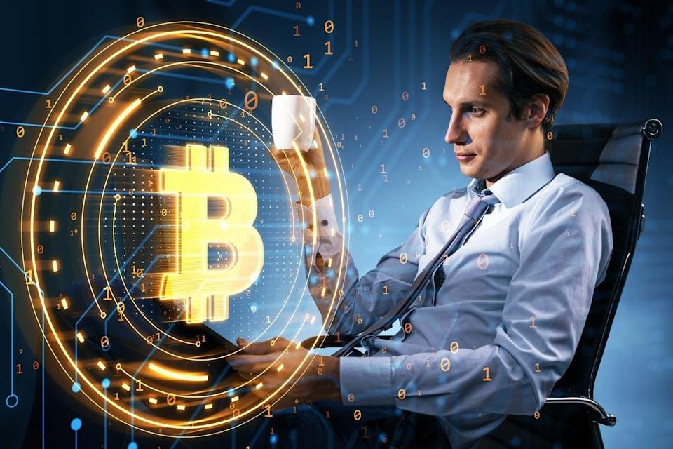 Businessman holding a cup while looking at a glowing Bitcoin symbol surrounded by digital elements on a blue background, concept of cryptocurrency and blockchain technology, creative photo