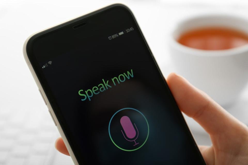 A phone that says speak now with a microphone symbol. 