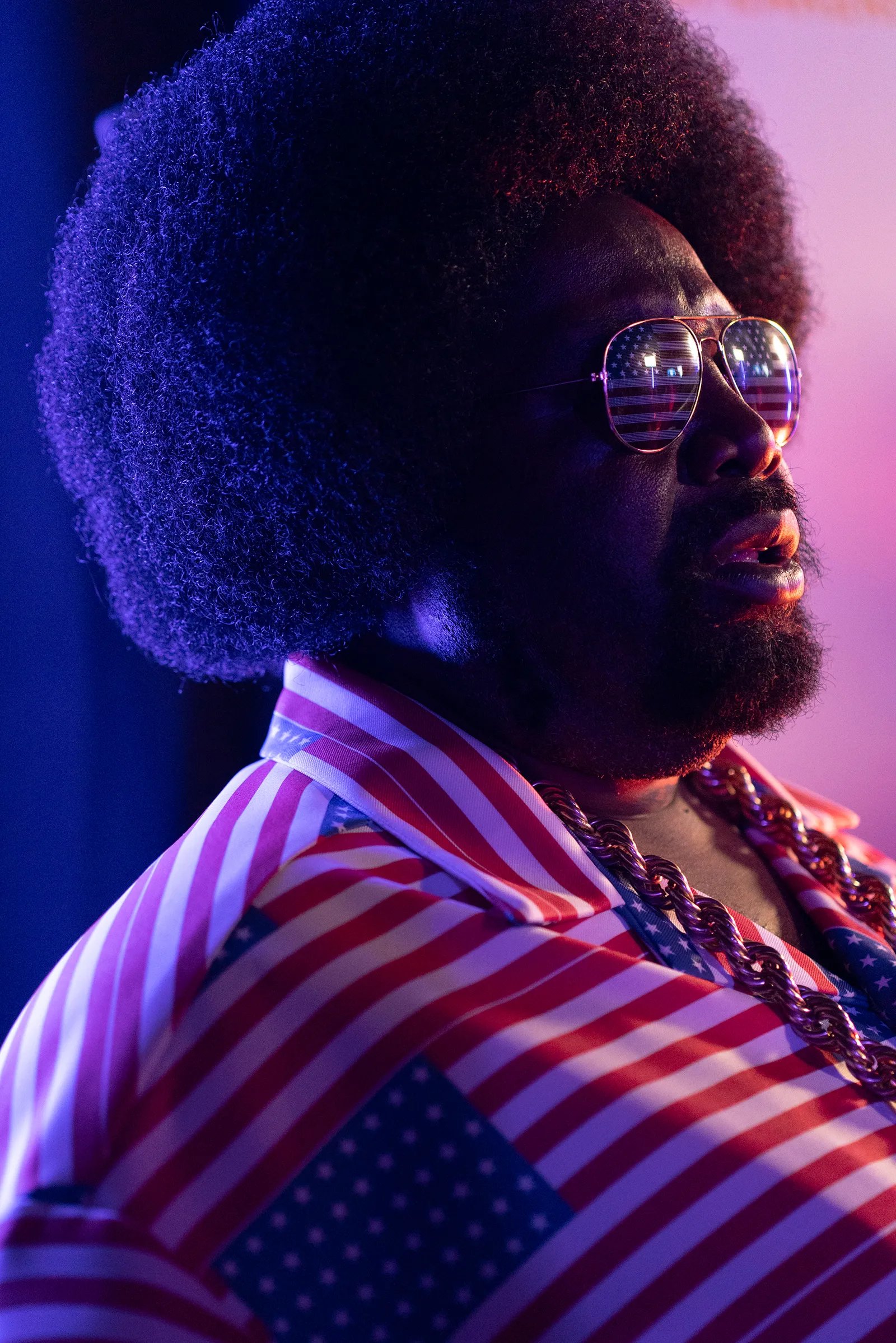 Image may contain Afroman Accessories Sunglasses Face Head Person Photography Portrait Adult Purple and Glasses